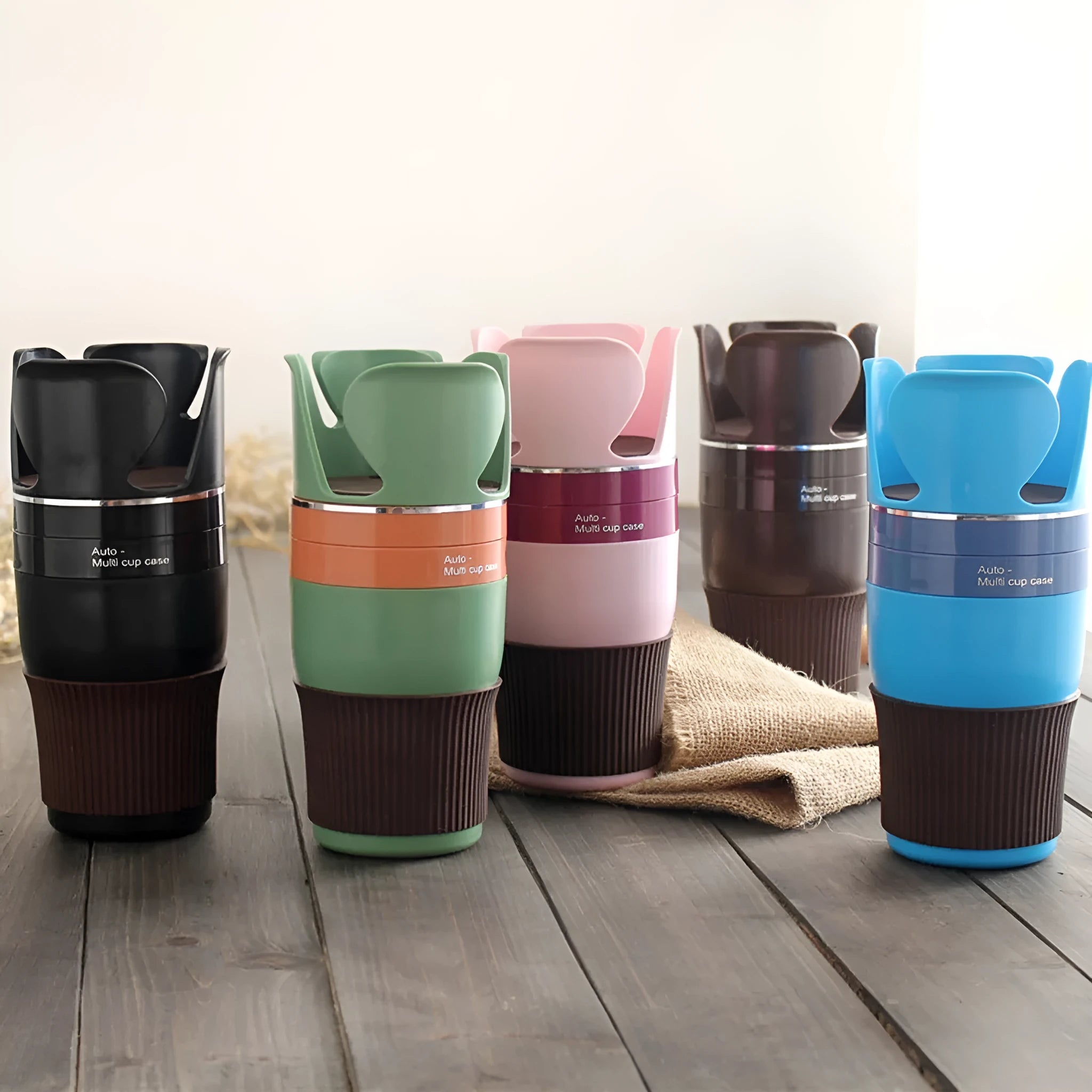 Car multifunctional cup holder and navigation mount organiser in black, brown, pink, green, or blue colours.