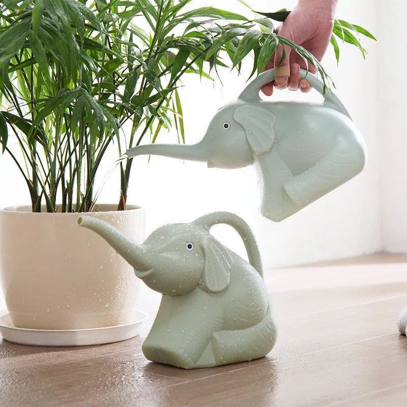 Pink plastic elephant-shaped watering can with a long nozzle and a child-sized handle.
