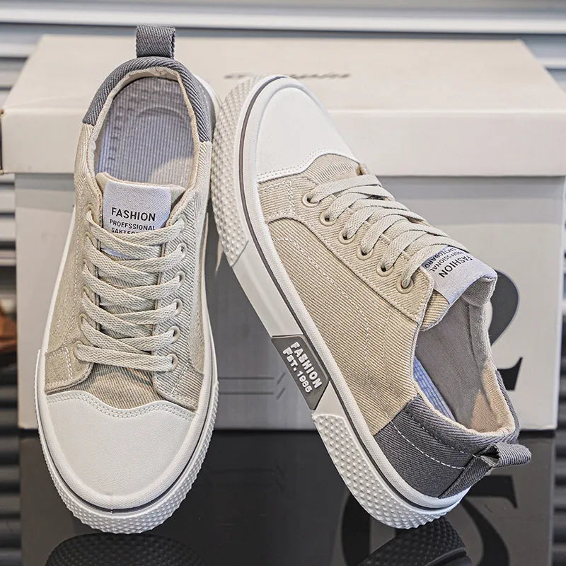 Men's low top casual canvas shoes in blue with round toe and front lace-up, on a plain background.
