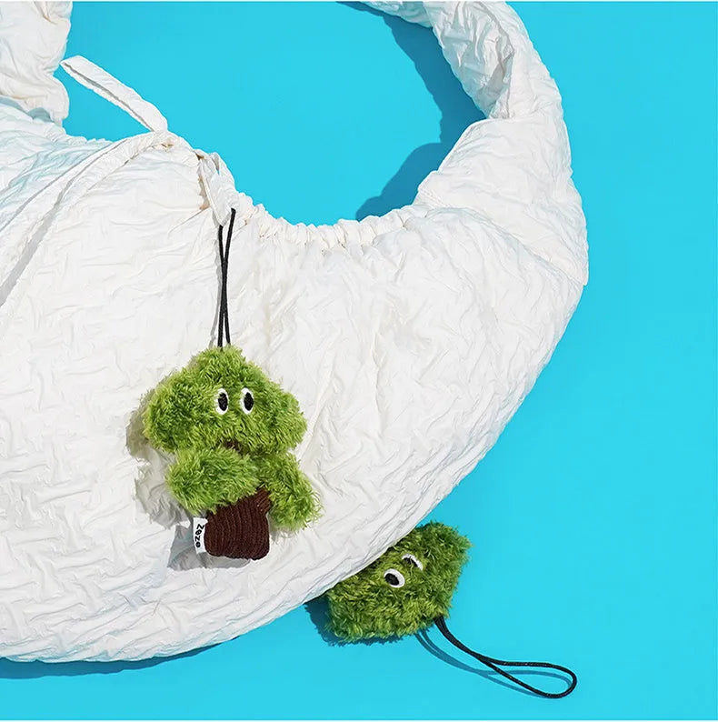 Pine tree shaped hanging cat toy with textured surface and bag of catnip.