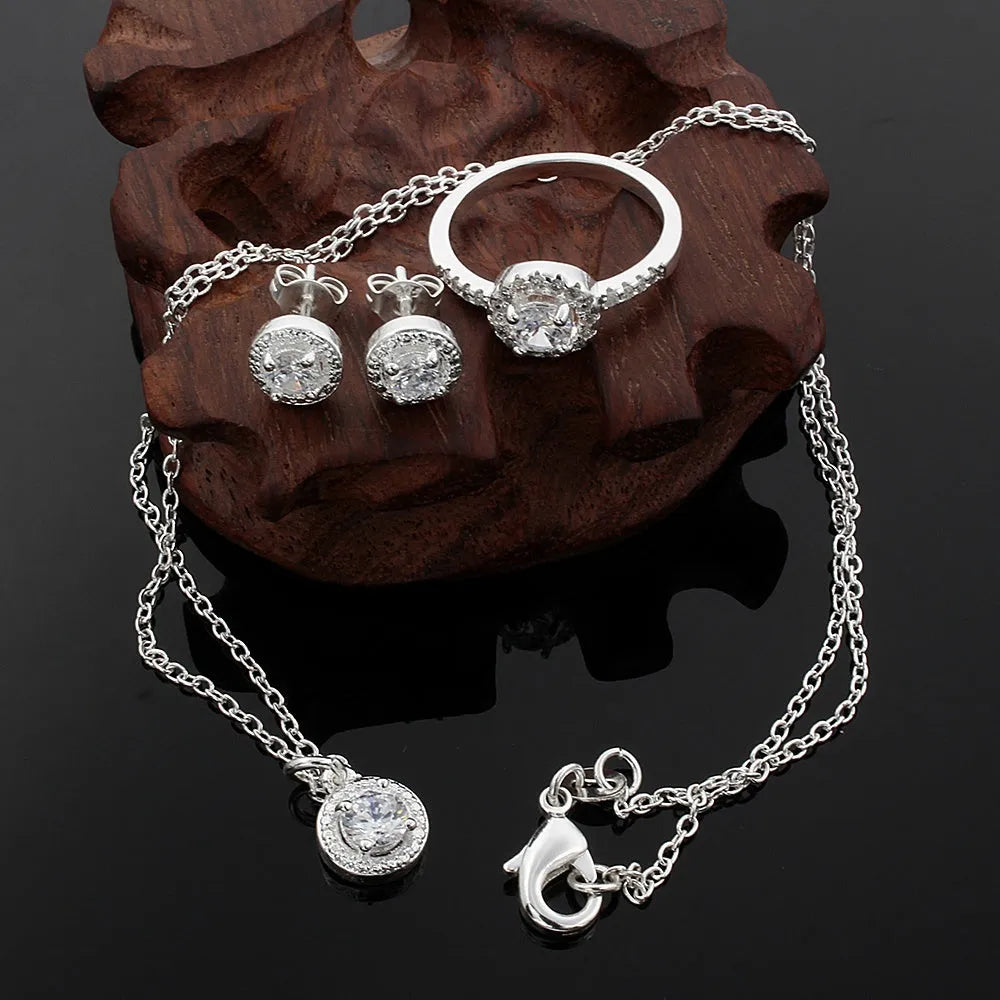 Zircon jewellery suit with inlaid apple ring and necklace silver tone on white background