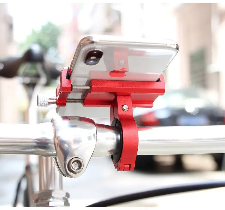 Aluminium bicycle phone holder mounted on a handlebar, showing a smartphone secured in the 360-degree rotating clamp.