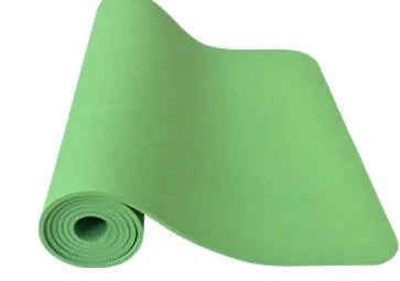6mm TPE beginner yoga mat in black, rolled on wooden floor with textured non-slip surface visible