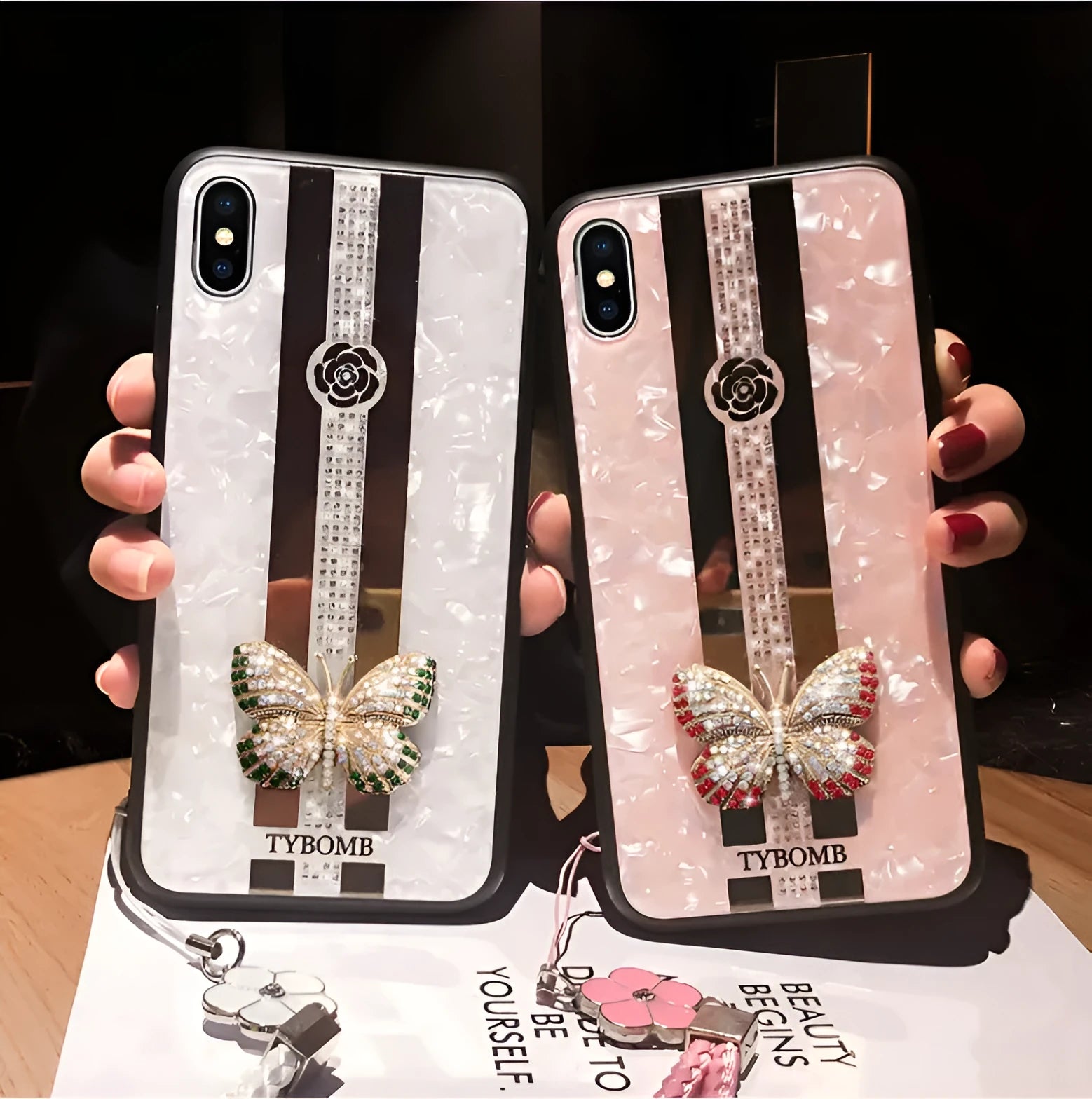 Luxury acrylic iPhone case with butterfly and diamond crystal design and a mirrored back in purple colour.
