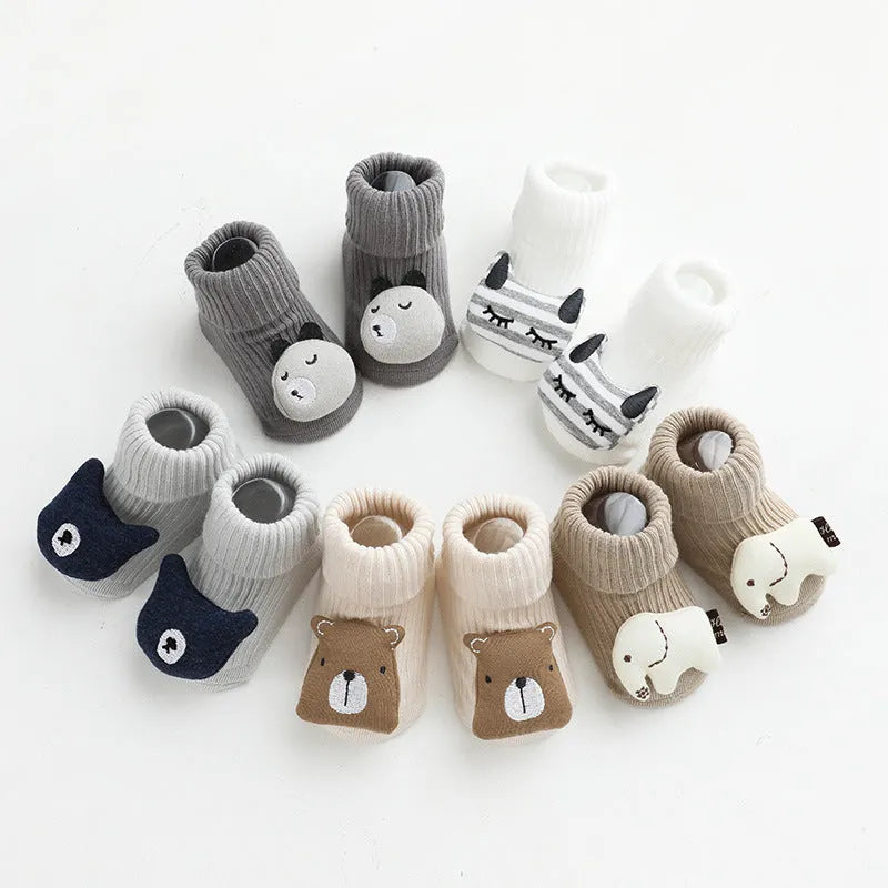 Baby socks with anti-slip dispensing glue in combed cotton, shown in multiple colours including blue bear print and pink cat.