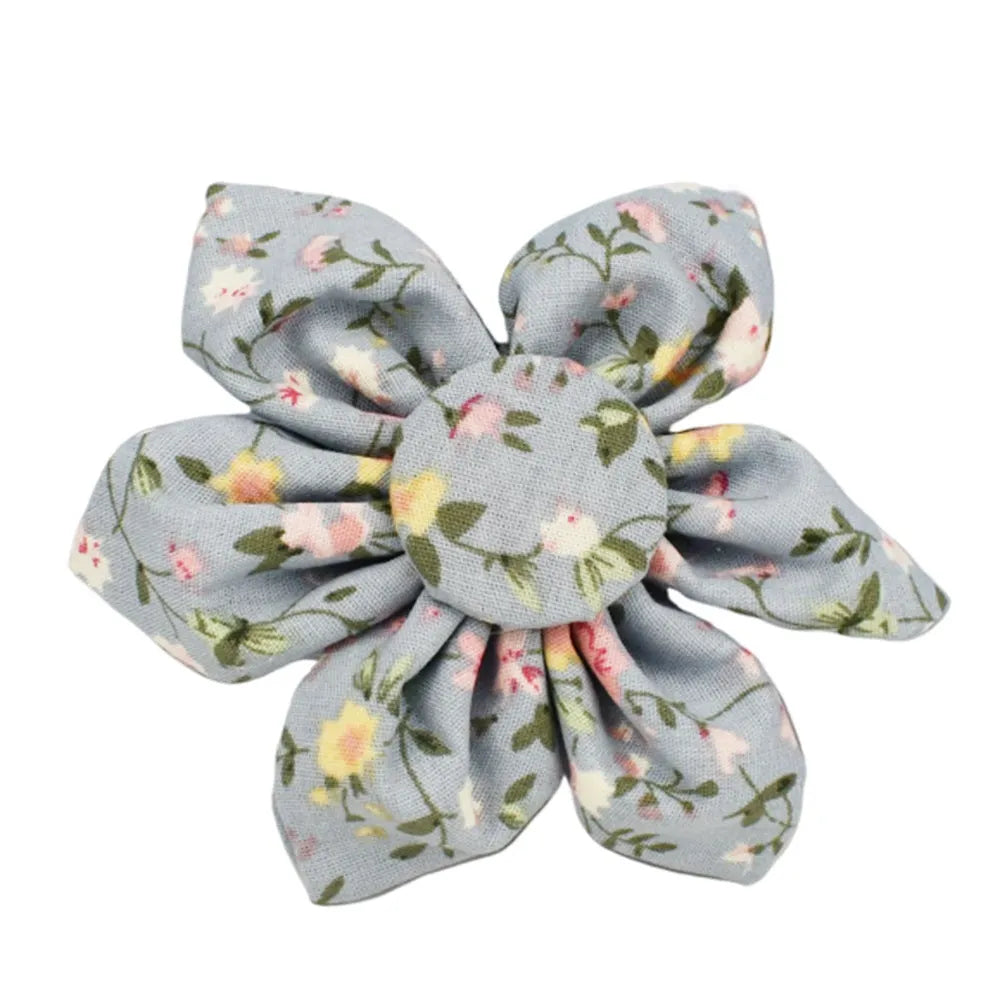 Blue floral patterned adjustable dog collar with matching leash, bow, and vest on a white background.