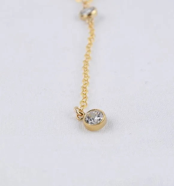 Gold colour alloy geometric pendant necklace with snake bone chain on display