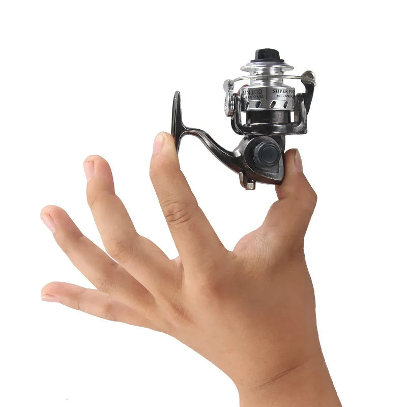 Mini 100 all metal fishing reel in black colour with folding rocker arm and wooden handle