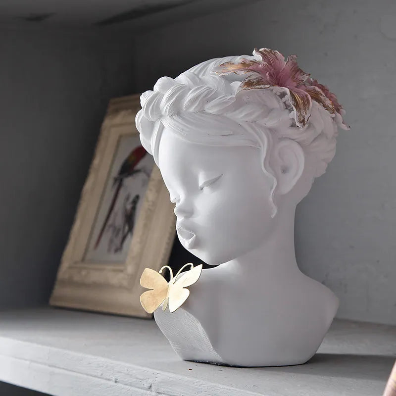Nordic style resin character figurine in light blue and white on a desktop