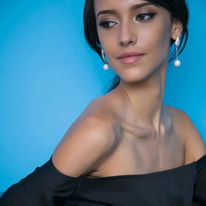 Silver angel wing earrings with diamond treatment and gold-plated gemstone accents