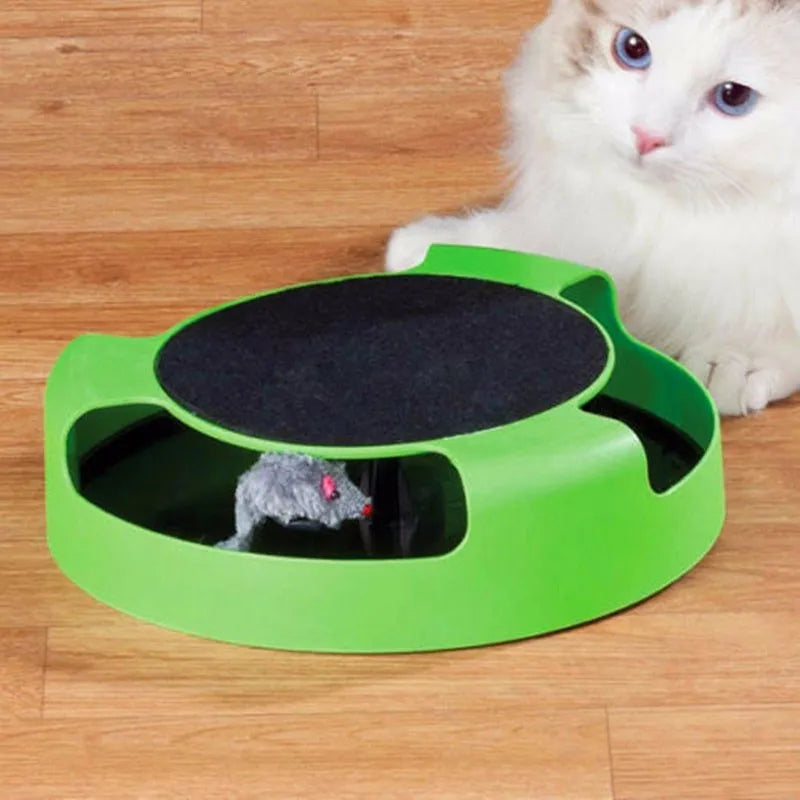 Blue rotating plastic cat toy with felt scratchpad on top standing on a floor