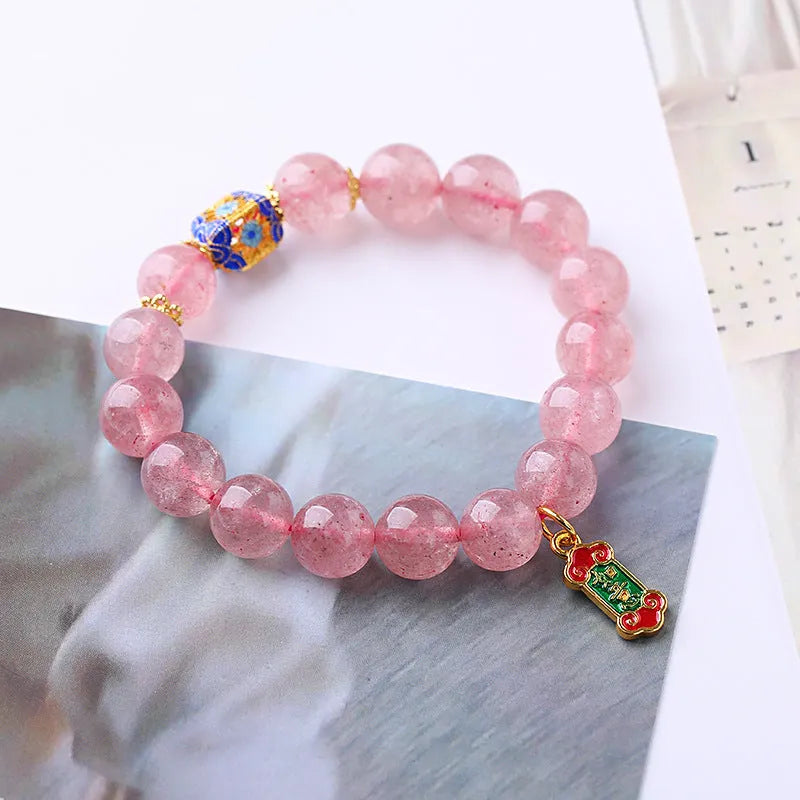 Pink strawberry quartz crystal bracelet with Ruyi charm and hand-woven design for women.