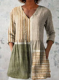 Women's loose-fit dress with blue and white wave pattern print and three-quarter length sleeves.