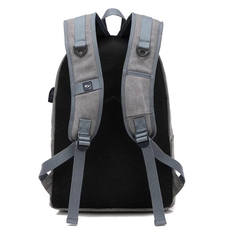 Canvas backpack with USB charging port and multiple compartments including separate laptop pocket