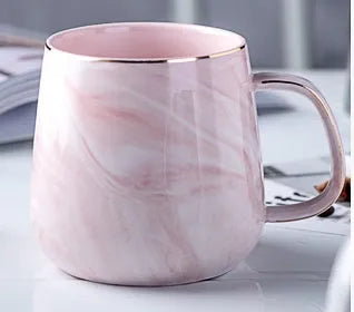 Ceramic mug with marble pattern, 320ml capacity, grey colour, on a table