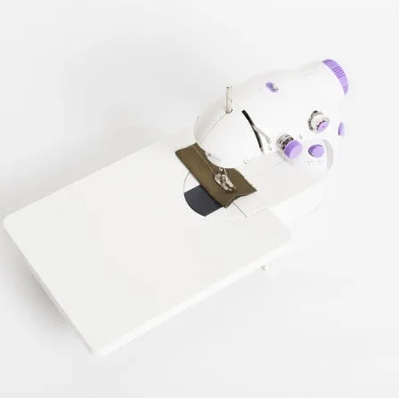 Miniature electric household sewing machine measuring 20 x 15 x 10 cm with straight stitch cylinder