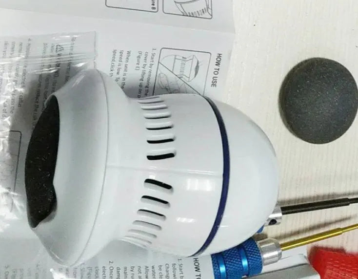 Beige and white electric foot file grinder with USB cable and grinding heads