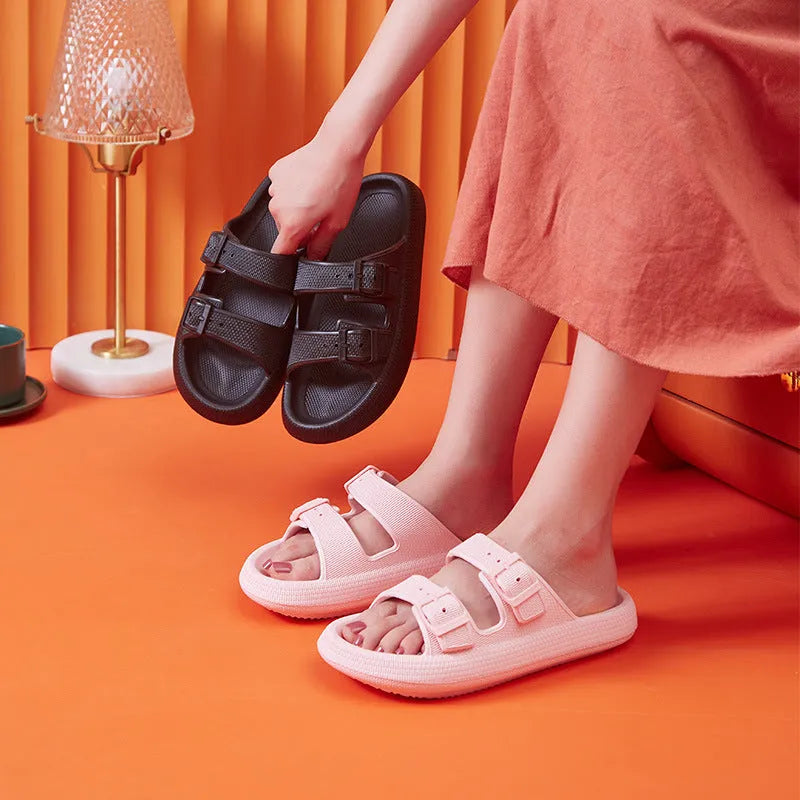 Women's beige platform slippers with buckle fastening and round toe on a flat surface