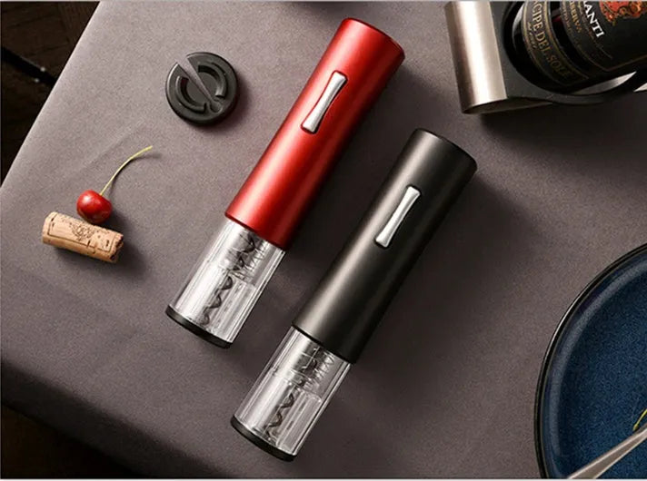 Automatic electric wine opener with black ABS shell and foil cutter set on a table alongside a wine bottle