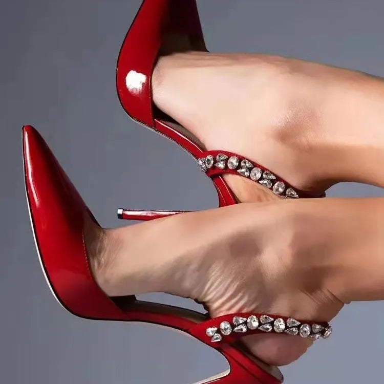 Women's black patent leather rhinestone pointed toe high heel sandals on a white background.
