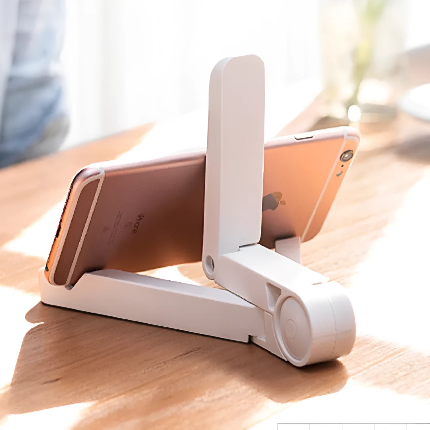Black foldable tablet holder showing folded size next to tablet for scale