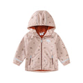 Pink floral children's rain jacket and pants set with hood, reflective details, and loose fit on a child outdoors