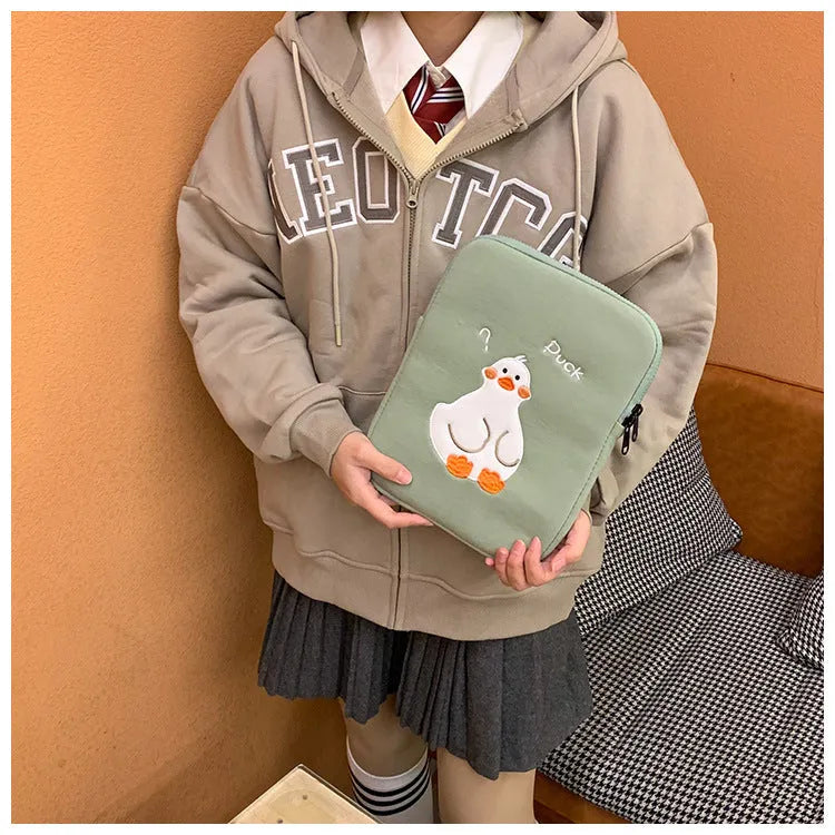 Blue cotton tablet case with embroidered cartoon duck design and a zipper closure.