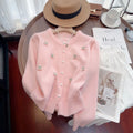 Pink cashmere blend cardigan with beaded detailing on the front, shown with a round neck and slim fit.