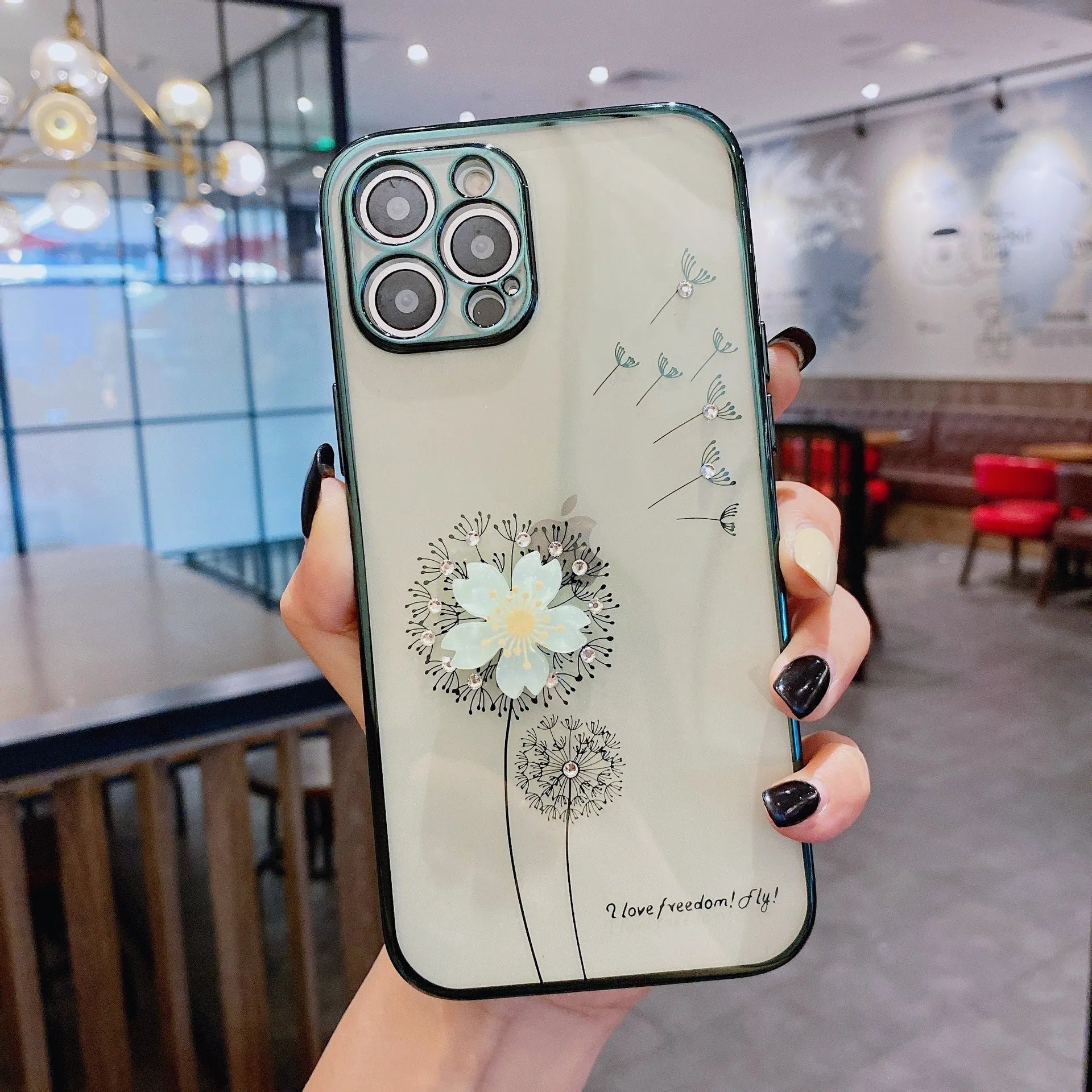 Green iPhone case with a 3D white flower spin stand on the back, showing the built-in screen protector.