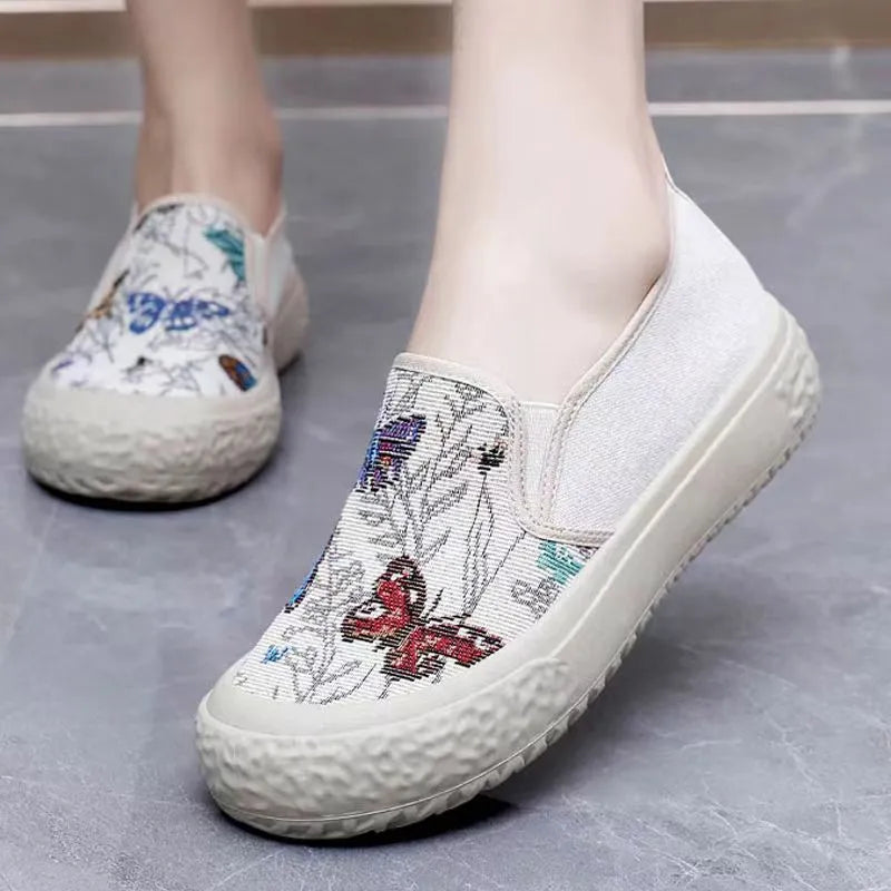 Women's slip-on canvas shoes in Black with round toe and decorative sewing thread details