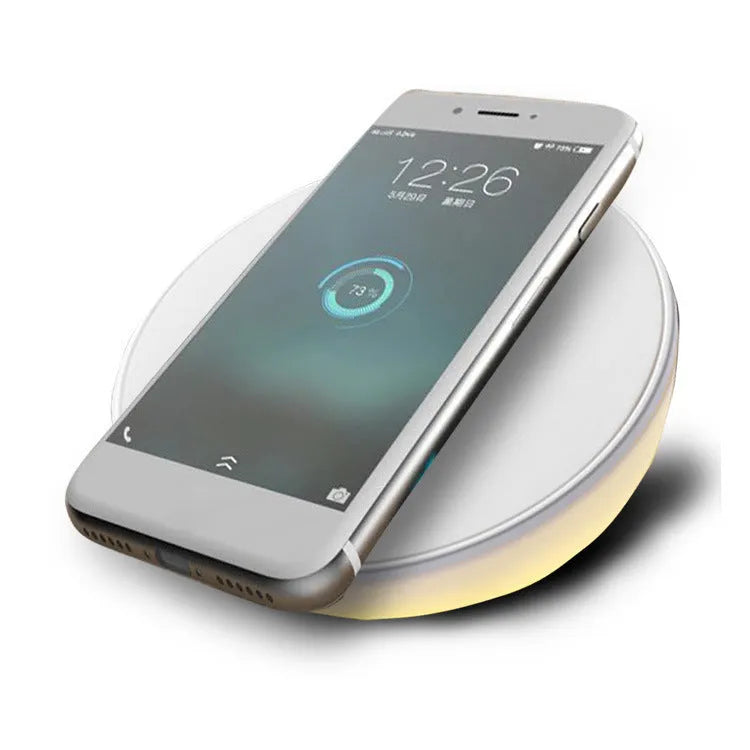 White wireless charger with clock display and three control buttons for smartphone charging