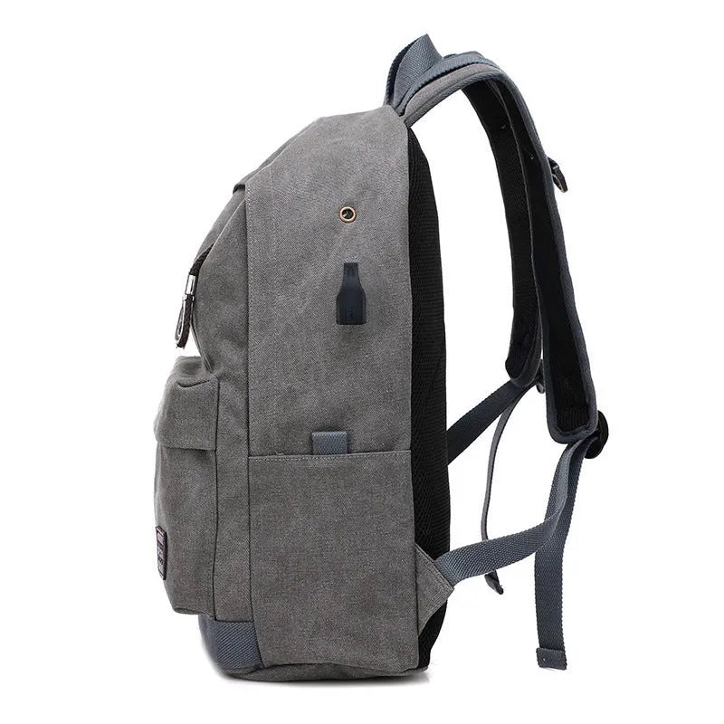 Canvas backpack with USB charging port and multiple compartments including separate laptop pocket