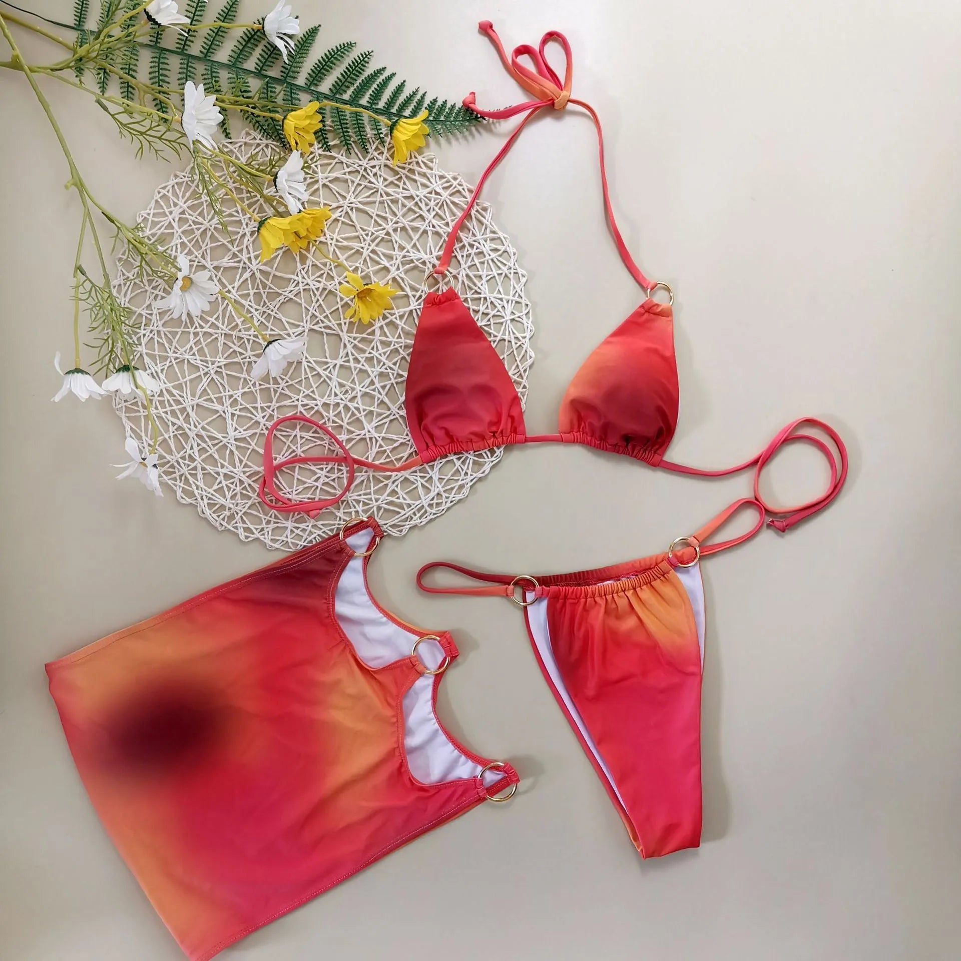 Women's solid colour tie-dye three-piece halter bikini swimsuit set with top, pants, and skirt.