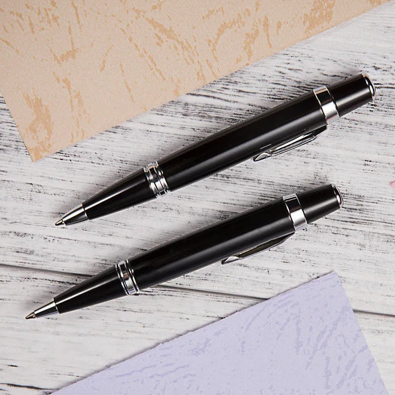 Short black metal ballpoint pen with rotating mechanism shown retracted and extended.