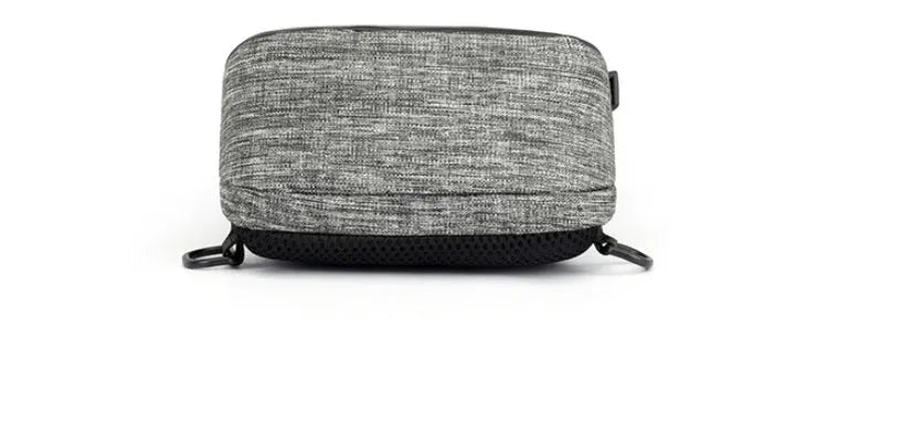 Small dark blue oxford cloth chest bag with a zipper and adjustable strap, showing internal phone pocket.