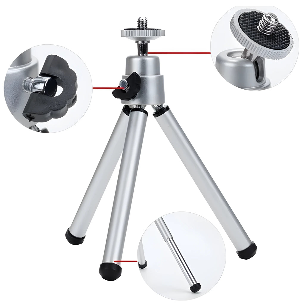 Compact mini desktop tripod with extendable aluminium legs and a black U-shaped phone clip attached.