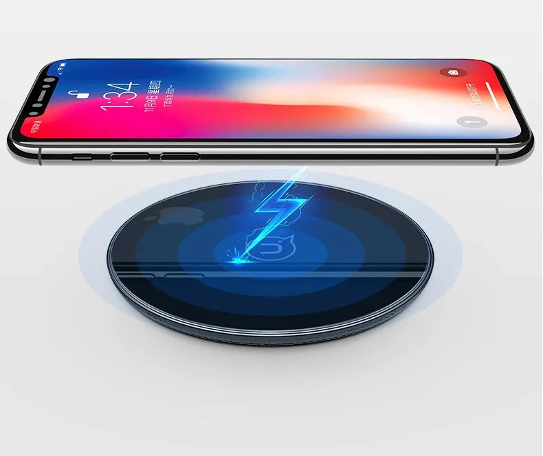Black or white glass disc wireless charger on a surface, showing status light.
