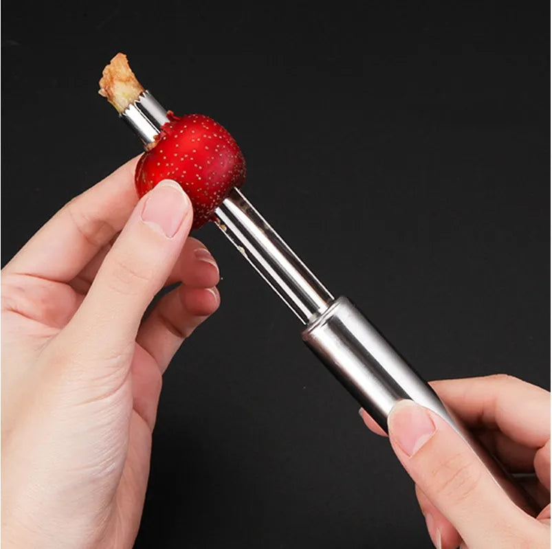 Stainless steel pineapple corer slicer with coloured ABS handle on a kitchen counter