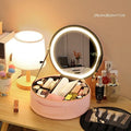 Round pink PU leather makeup bag with built-in LED illuminated mirror and internal cosmetic partitions open.