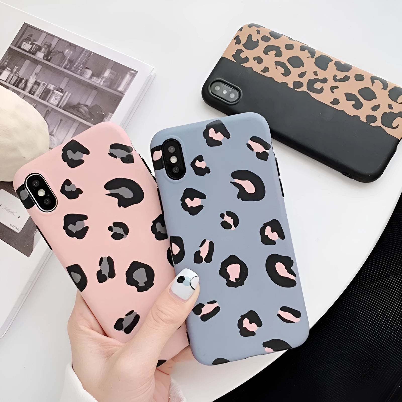 Leopard print phone case for iPhone in black, blue, and pink colours showing front and back views.
