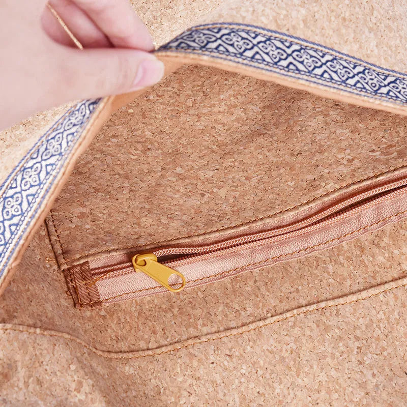 Cork yoga backpack with bohemian style, wide shoulder straps, and multiple pockets for mat, water bottle, and accessories.