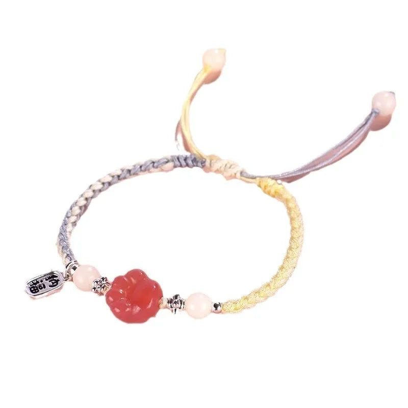 Red glass cat's paw charm bracelet with woven cord in pink or yellow for couples