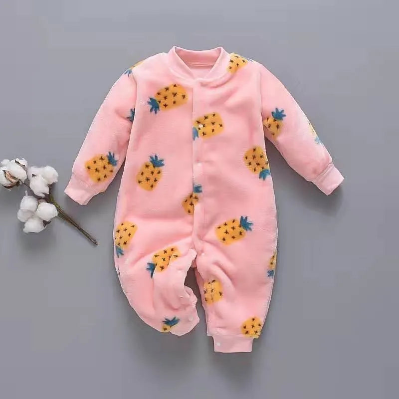 Baby wearing a long-sleeved flannel romper in a pink bunny head print, showcasing the 100% cotton fabric.