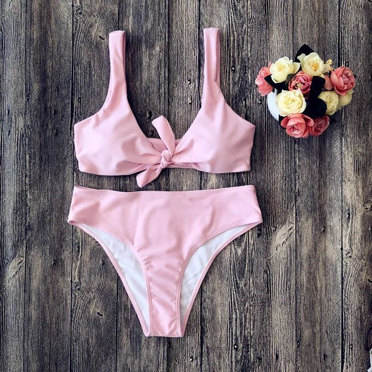 Women's solid colour bikini set with bra top and briefs in black, pink, red, white, or wine red.