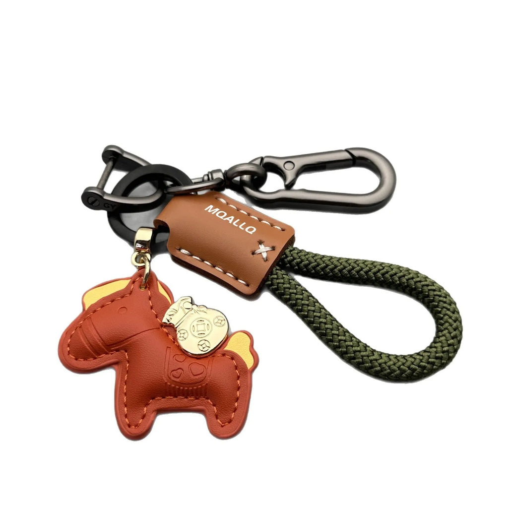 Handmade brown cowhide leather keychain with a zinc alloy pony belt buckle on a green flanelle rope.