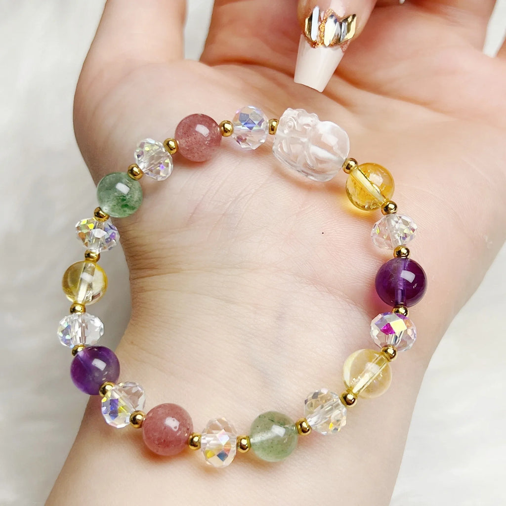 Close-up of a women's crystal bracelet with a detailed nine-tailed fox charm and colour faceted stones.