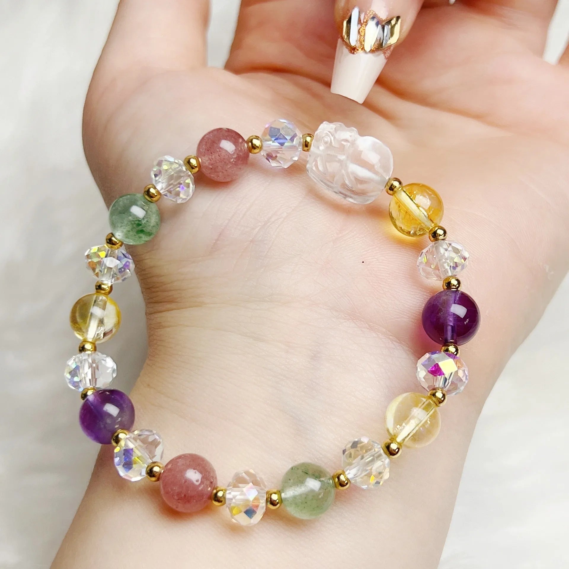 Close-up of a women's crystal bracelet with a detailed nine-tailed fox charm and colour faceted stones.