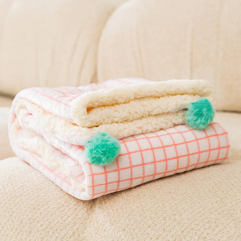 Blue coral fleece pet blanket shown in a large size on a wooden floor