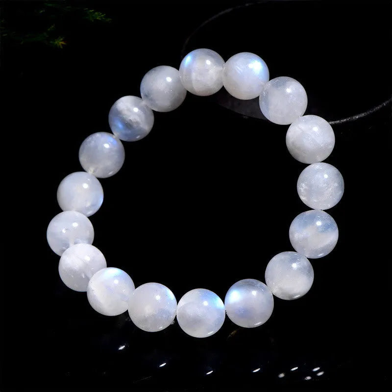 Natural white Moonstone round bead bracelet on a wrist, showing polished geometry beads.