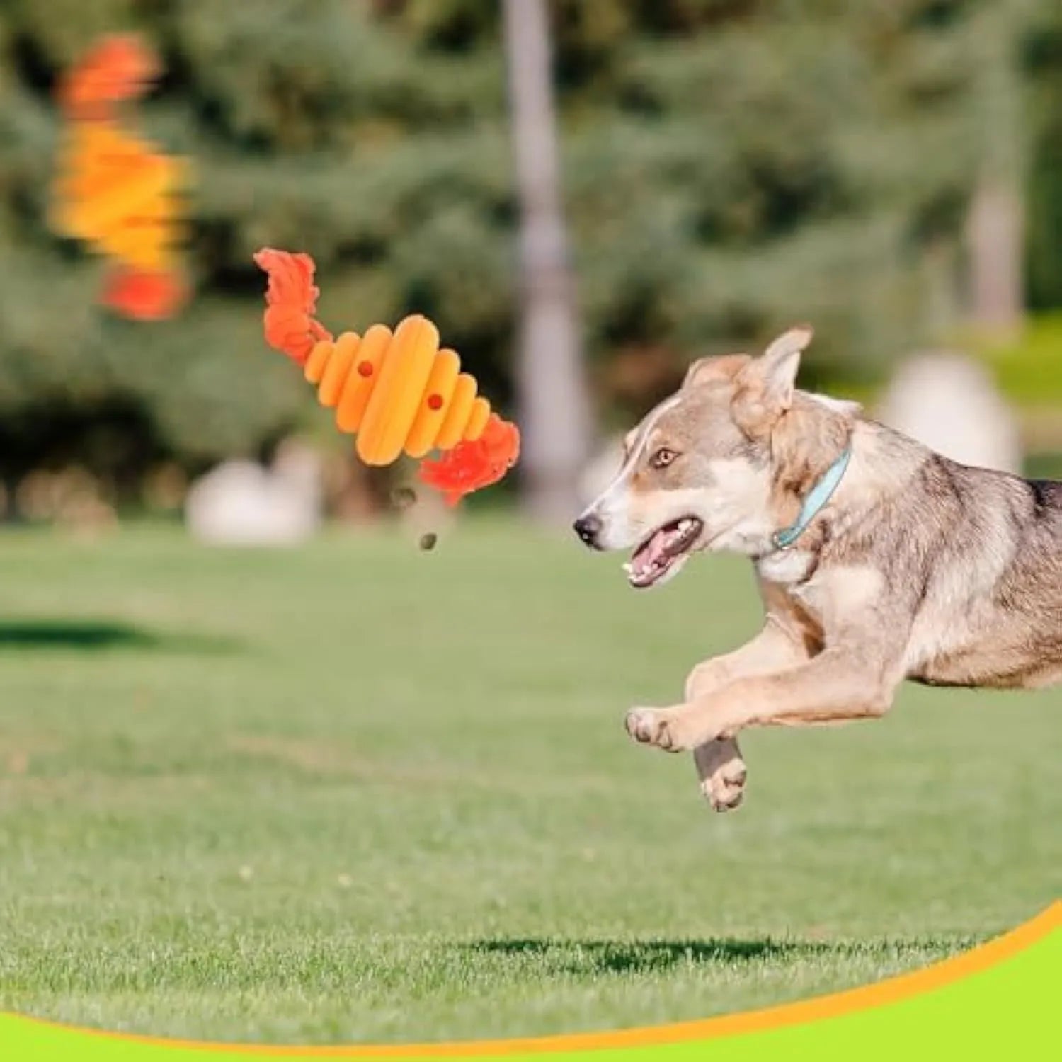 Green and yellow silicone dog ball with rope attachment for food dispensing and tug-of-war games